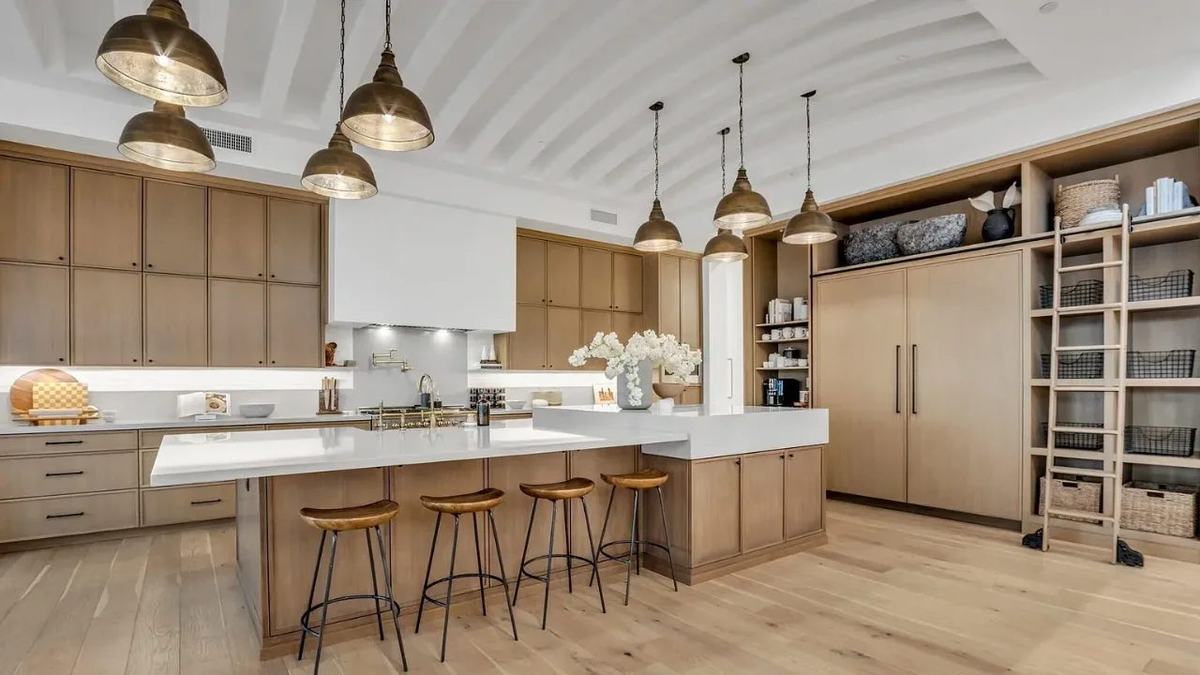 Restored kitchen with new cabinets, counters and flooring after water damage repairs